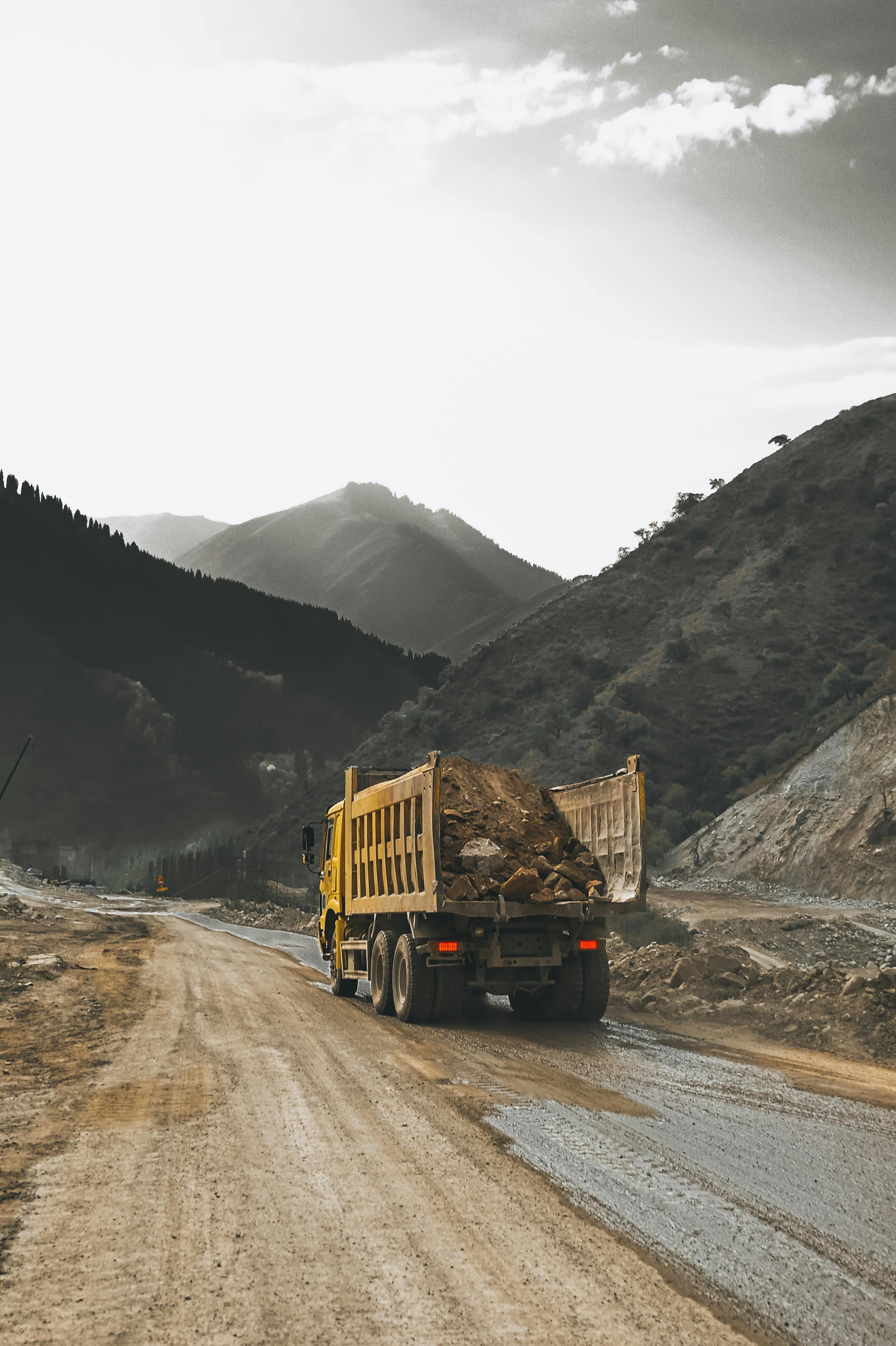 Excavator loading material into dumper